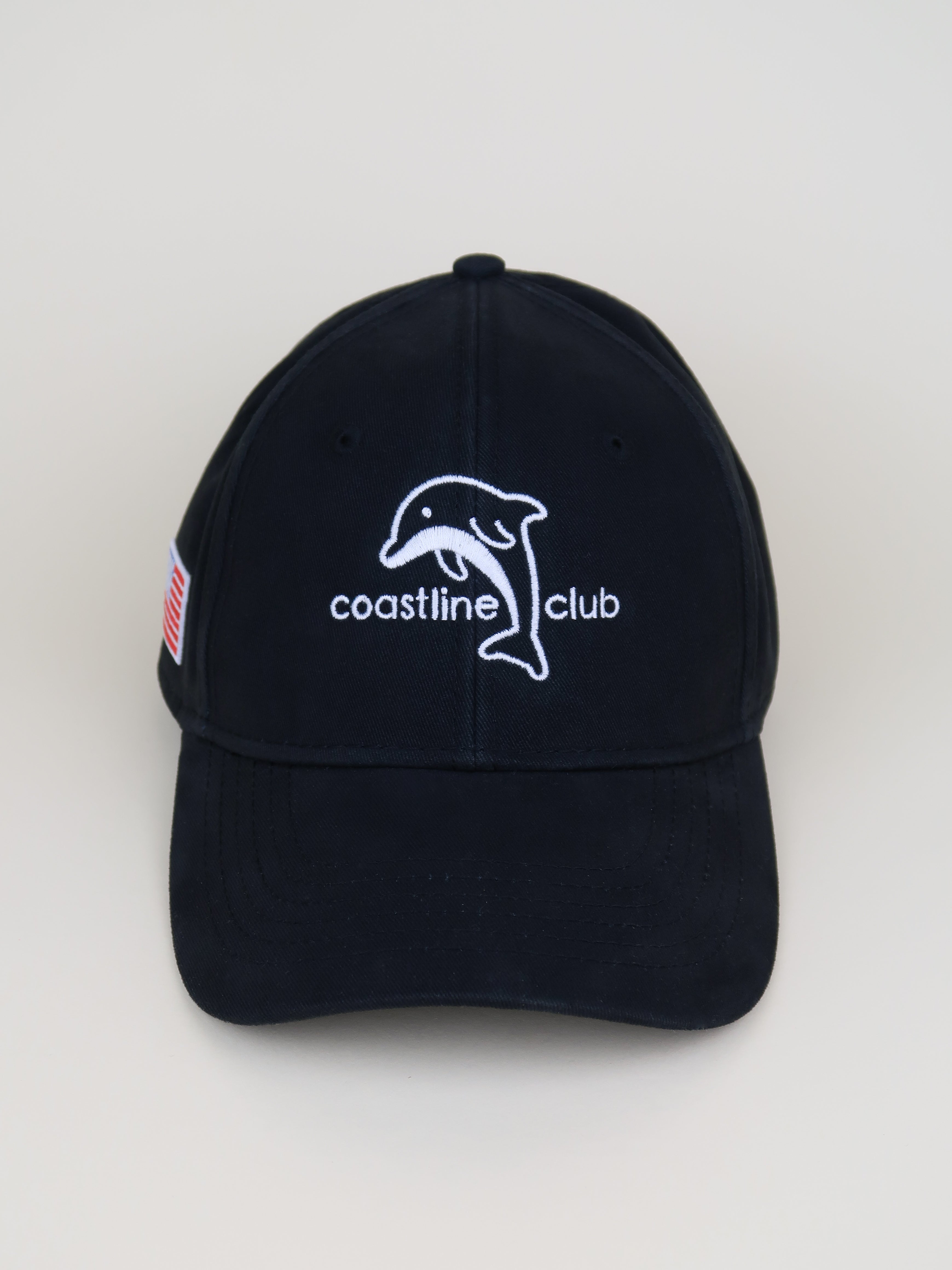 Black cap with 'coastline club' logo on a white background