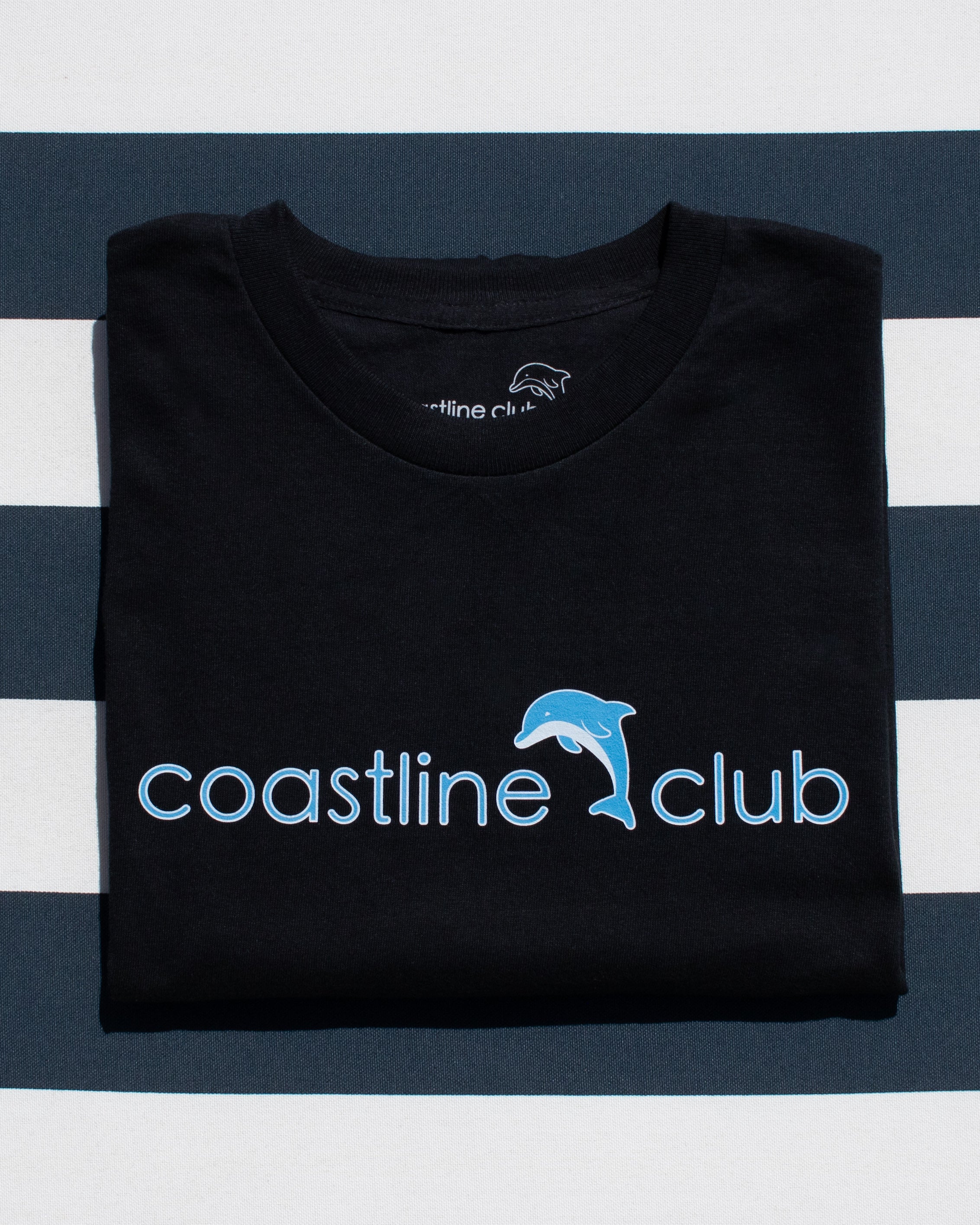 Black t-shirt with 'coastline club' logo on a striped background