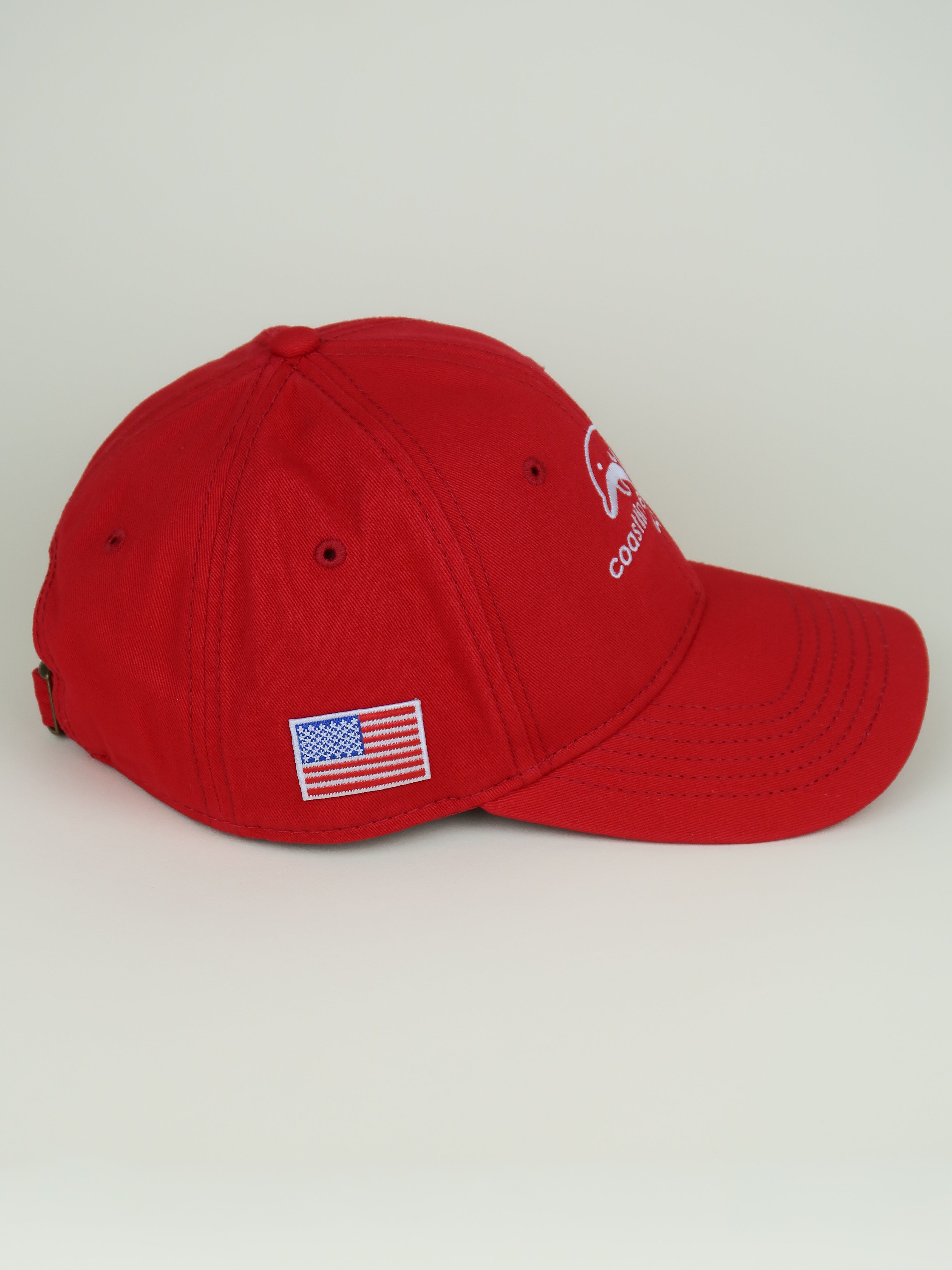Red cap with American flag patch on a light gray background