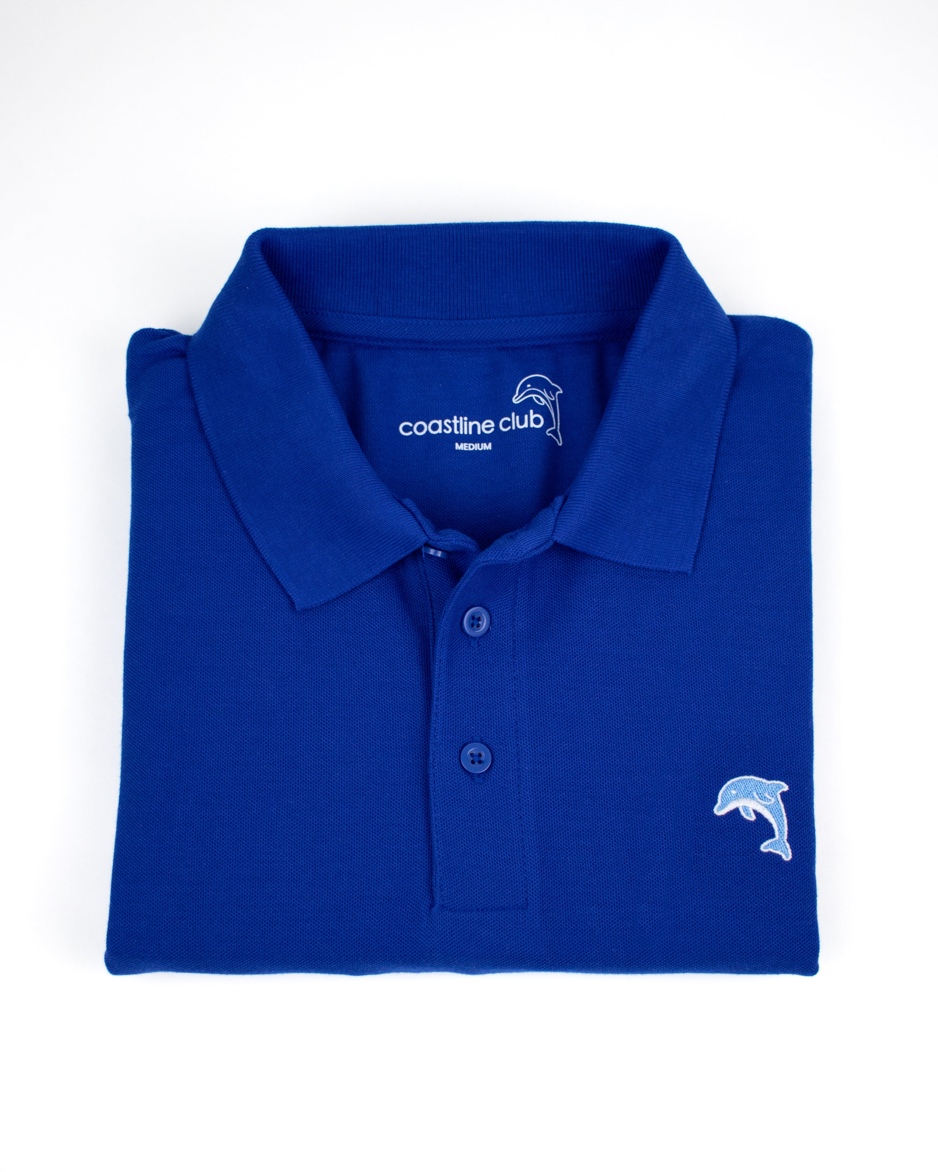 Folded blue polo shirt with a dolphin logo on a white background