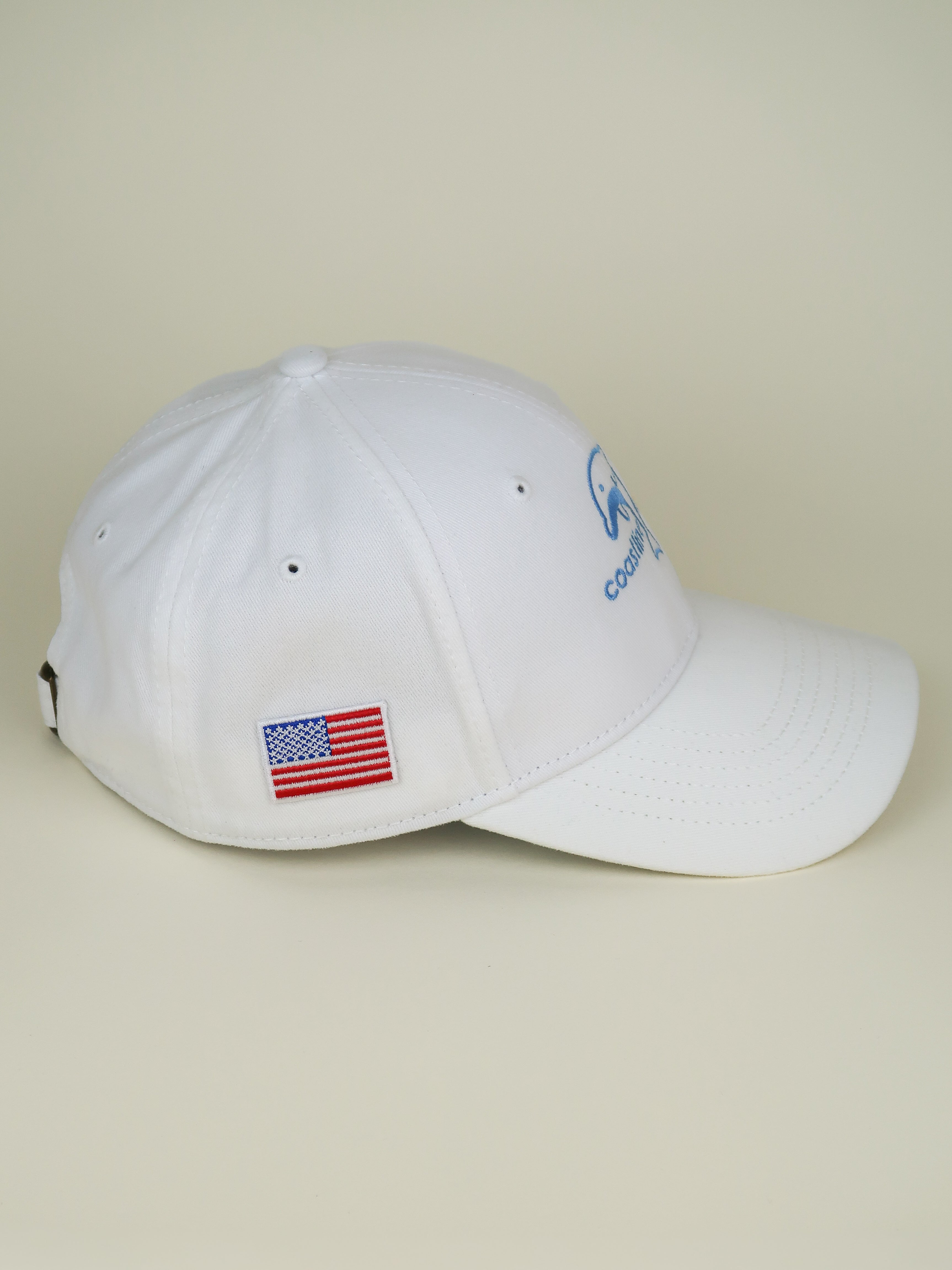 White cap with American flag patch on a beige background