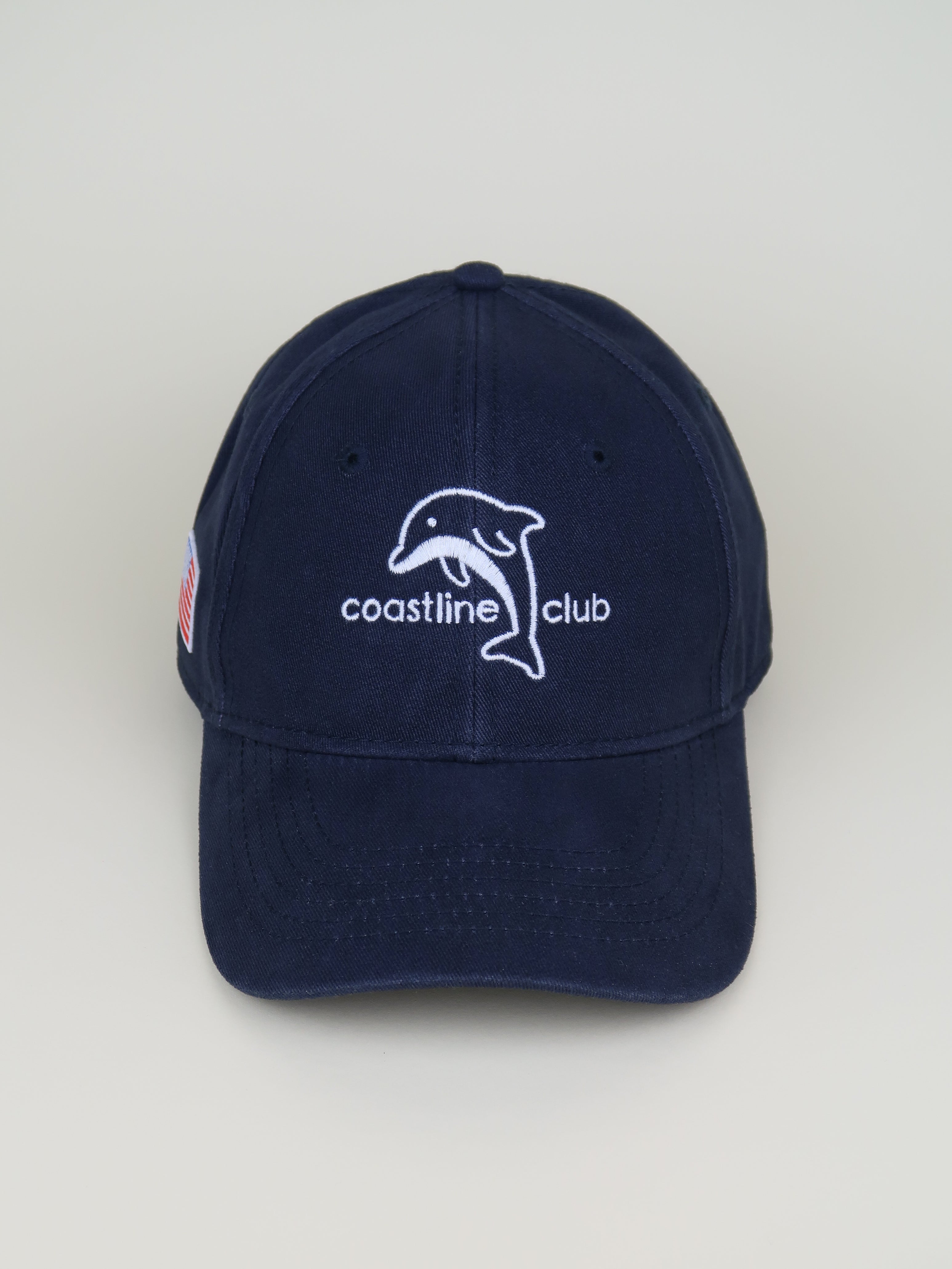 Navy blue cap with a dolphin logo and 'coastline club' text on a light gray background